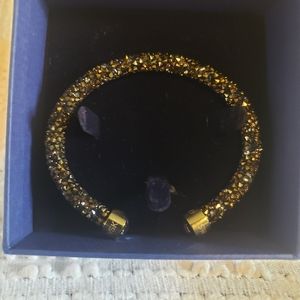 Swarovski cystal black and gold bracelet. Gold tone end cap.